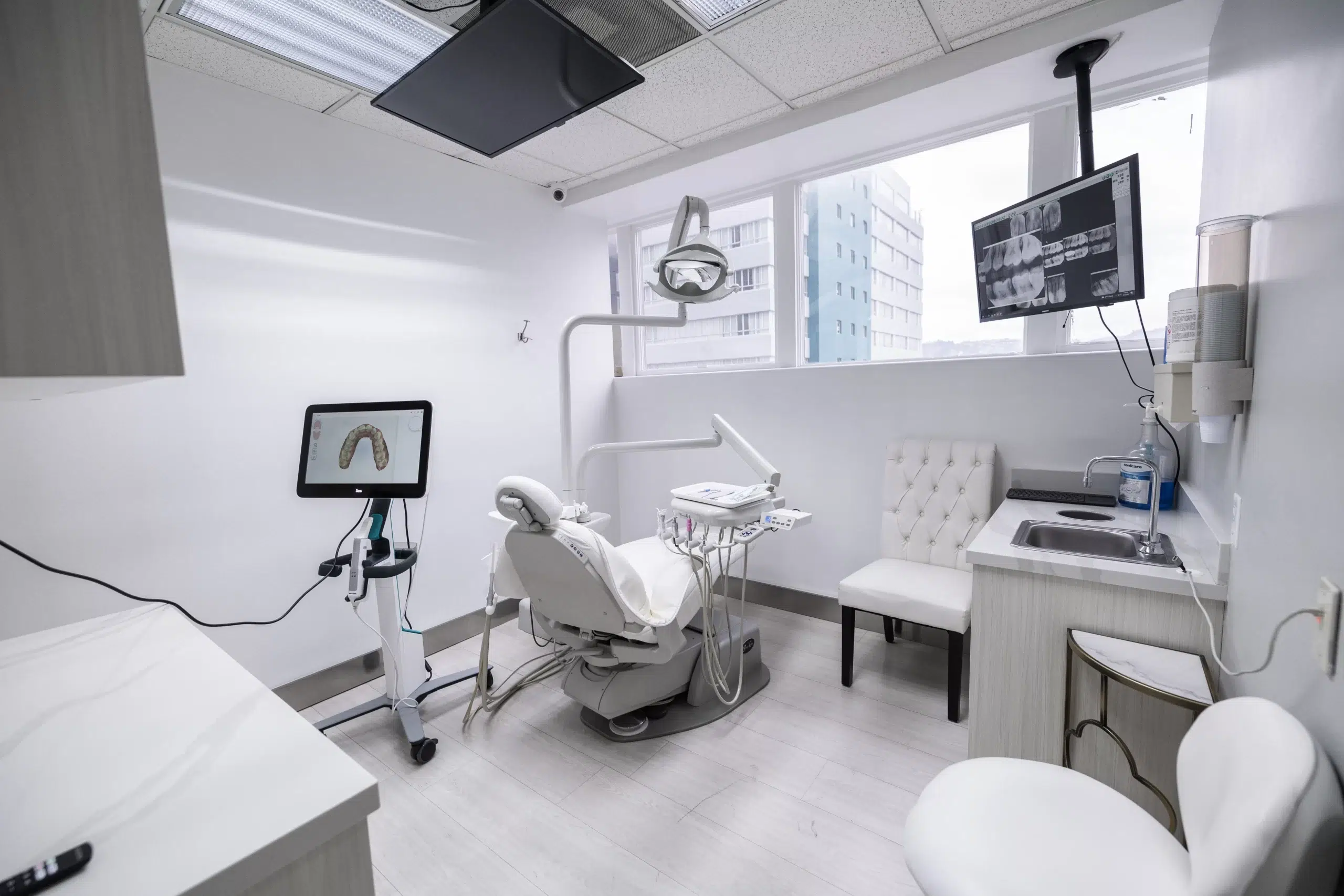 BLVD Dental Aesthetics treatment room with digital dental imaging displays