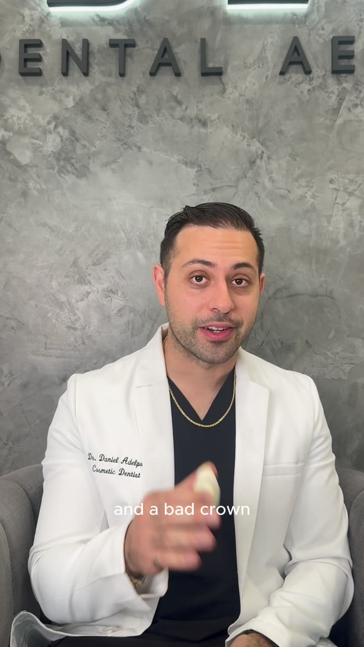 Dr. Daniel Adelpour holding a dental crown while explaining crown fit